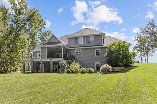 back of house with a lawn, a sunroom, and ceiling fan