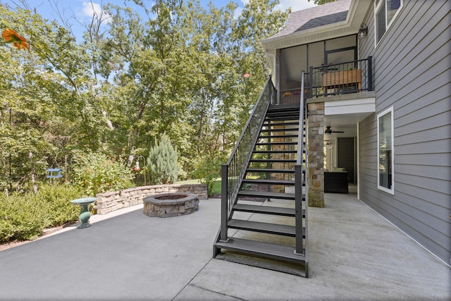 view of patio with a fire pit and a sunroom