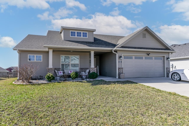 craftsman house with covered porch, a front yard, and a garage