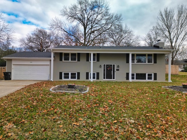 raised ranch featuring a front yard and a garage