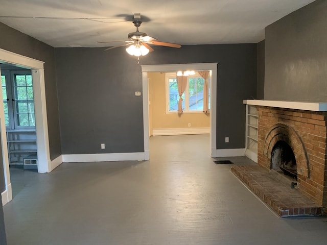 unfurnished living room with ceiling fan, a baseboard heating unit, a wealth of natural light, and a brick fireplace