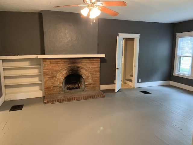 unfurnished living room featuring visible vents, a brick fireplace, concrete floors, and baseboards