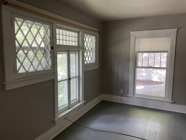 doorway to outside with wood finished floors and baseboards