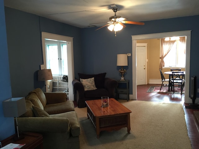 living room featuring baseboards and ceiling fan