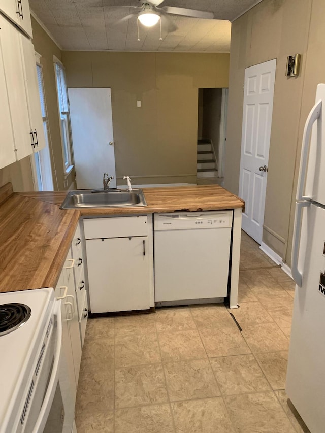 kitchen featuring a sink, white appliances, butcher block counters, and white cabinetry