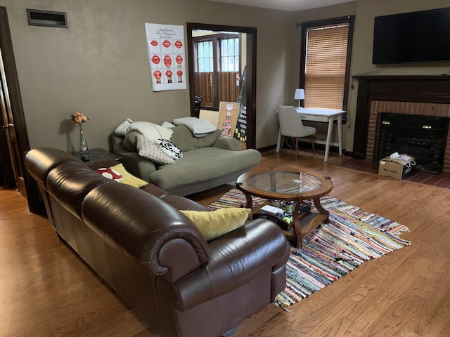 living room featuring hardwood / wood-style flooring and a fireplace