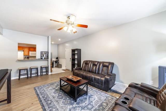 living room with ceiling fan and light wood-type flooring