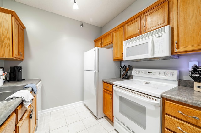 kitchen with light tile patterned floors and white appliances