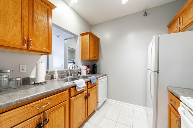 kitchen with light tile patterned floors, sink, and white appliances