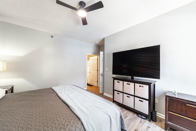 bedroom with ceiling fan and light hardwood / wood-style flooring