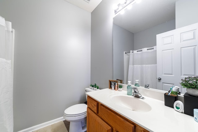 bathroom with toilet and vanity