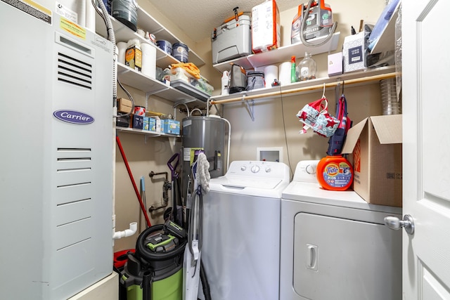 laundry room featuring water heater and independent washer and dryer