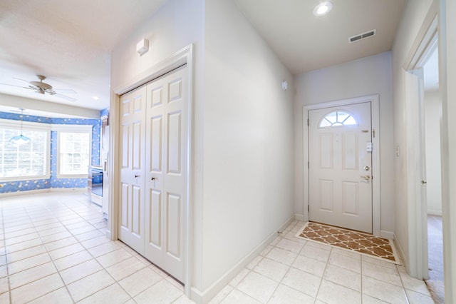 entrance foyer featuring ceiling fan and light tile patterned floors