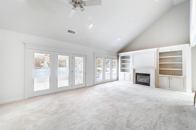 unfurnished living room featuring ceiling fan, light colored carpet, and high vaulted ceiling