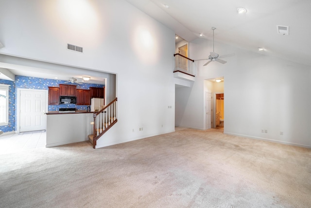 carpeted living room with high vaulted ceiling and ceiling fan