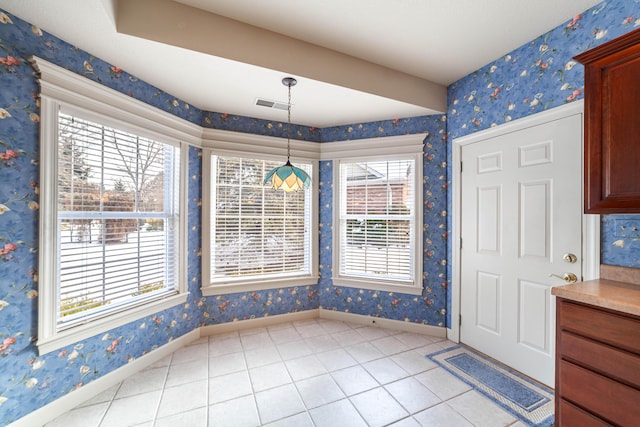 unfurnished dining area with light tile patterned floors