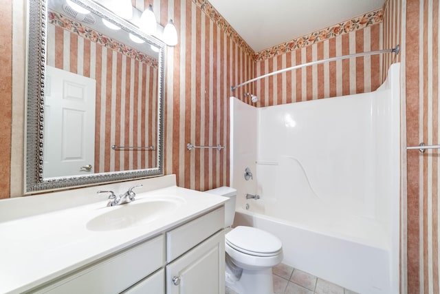 full bathroom with toilet, vanity, tile patterned flooring, and shower / tub combination