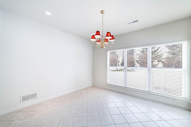 unfurnished room with light tile patterned floors and a notable chandelier