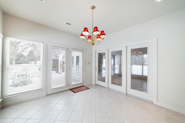 interior space featuring french doors and a notable chandelier