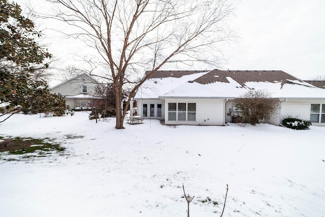 view of snow covered rear of property