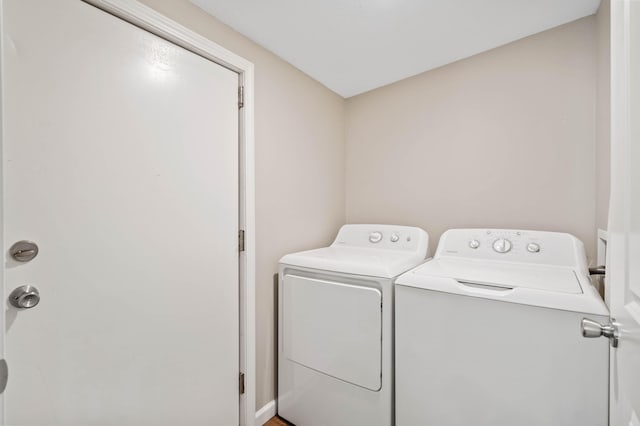 clothes washing area featuring washer and clothes dryer