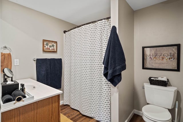 bathroom with curtained shower, hardwood / wood-style flooring, toilet, and vanity