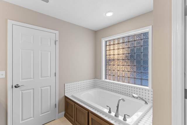 bathroom with tiled bath