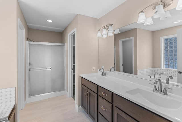 bathroom featuring an enclosed shower and vanity