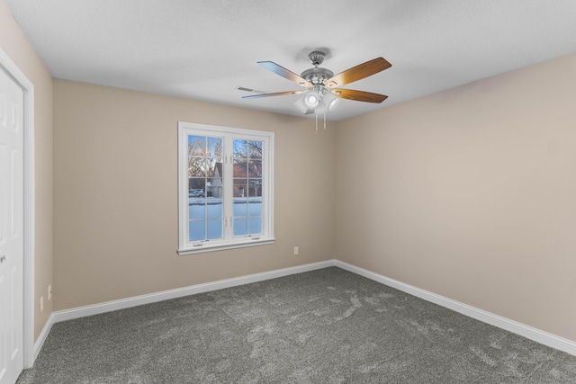 unfurnished room with ceiling fan and carpet