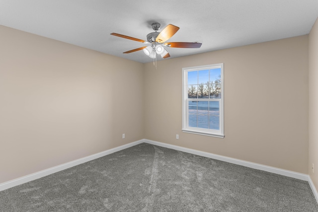 carpeted spare room featuring ceiling fan