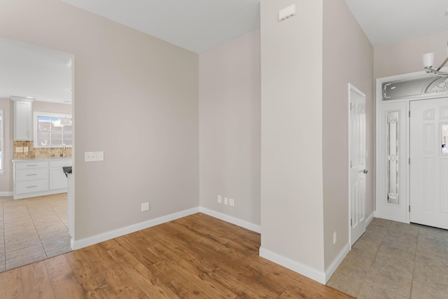 foyer entrance with sink and light hardwood / wood-style flooring