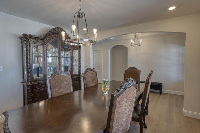 dining room with a notable chandelier and light hardwood / wood-style flooring