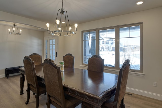 dining area featuring a chandelier and light hardwood / wood-style floors