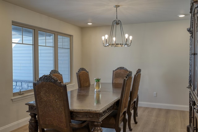 dining space featuring an inviting chandelier and light wood-type flooring