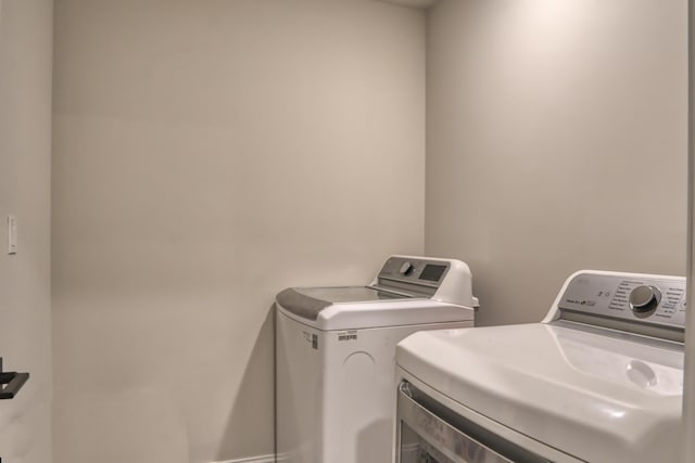 laundry area with independent washer and dryer