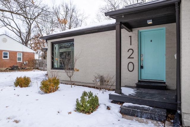 view of snow covered property entrance