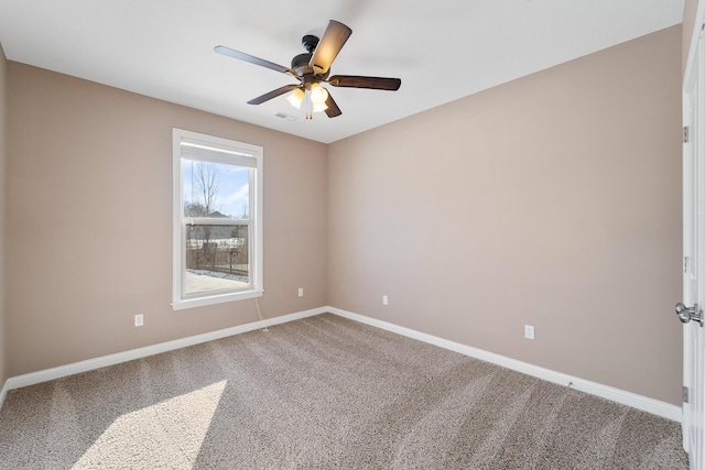 carpeted empty room featuring ceiling fan