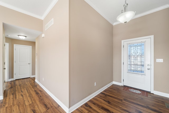 foyer entrance with dark wood-type flooring and ornamental molding