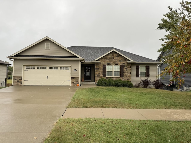 view of front of house featuring a garage and a front lawn