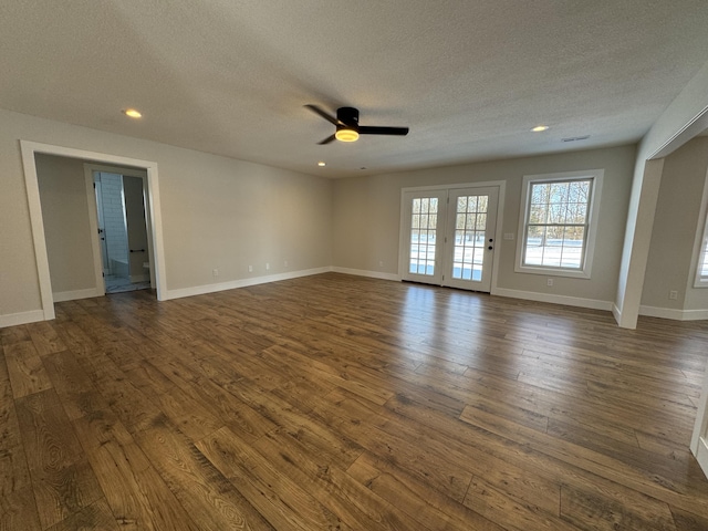 unfurnished room with ceiling fan, french doors, dark hardwood / wood-style floors, and a textured ceiling