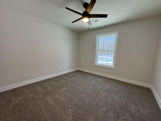 carpeted spare room with ceiling fan and a textured ceiling