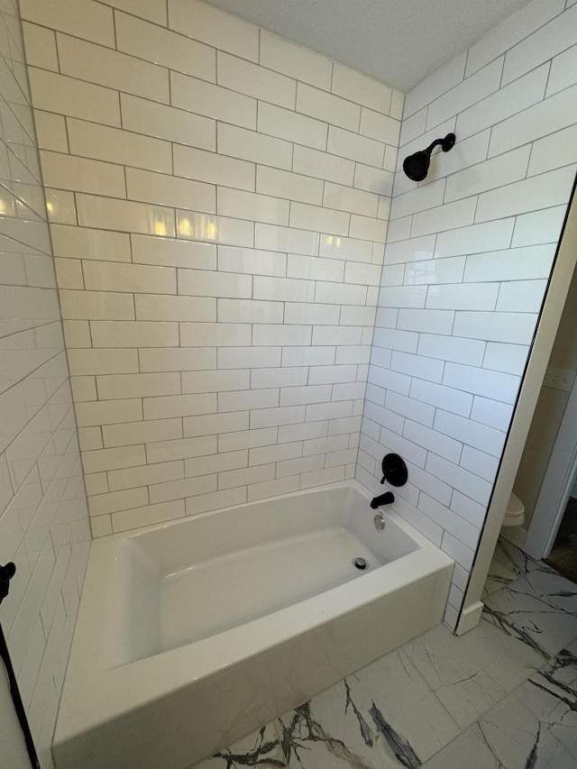 bathroom with toilet and shower / washtub combination