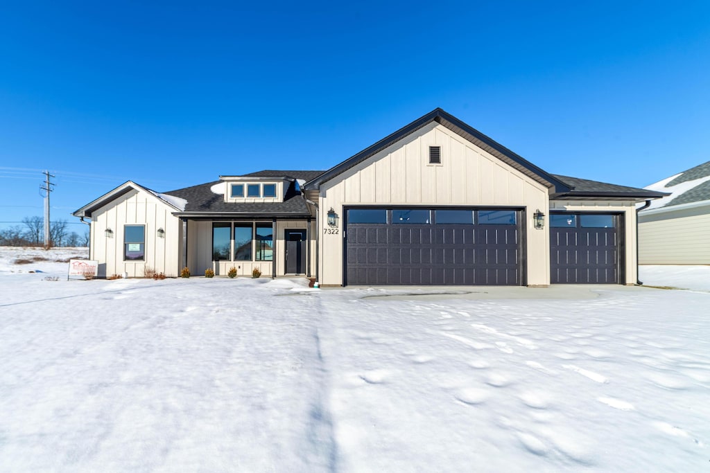 modern inspired farmhouse featuring a garage