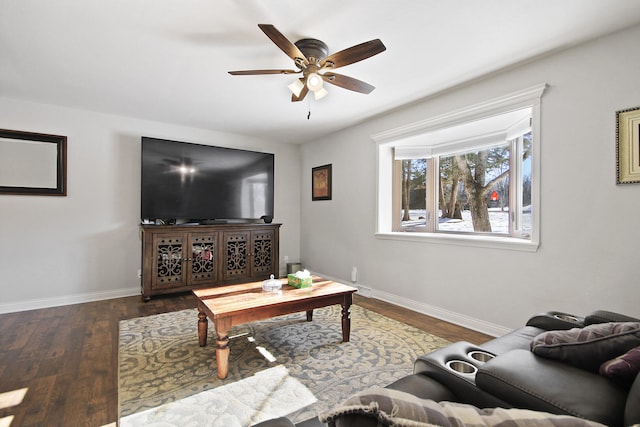 living room with ceiling fan and dark hardwood / wood-style floors