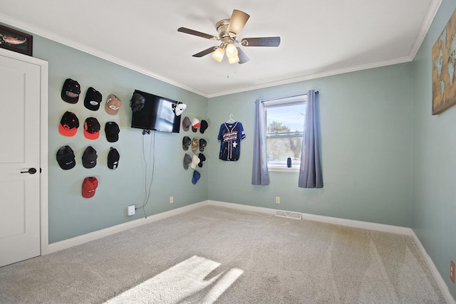 spare room with carpet floors, ceiling fan, and crown molding