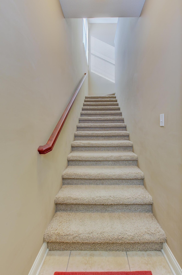 stairway with tile patterned flooring