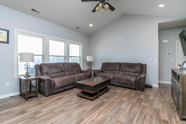 living room featuring light hardwood / wood-style floors, ceiling fan, and vaulted ceiling