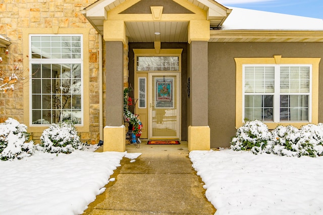 view of snow covered property entrance