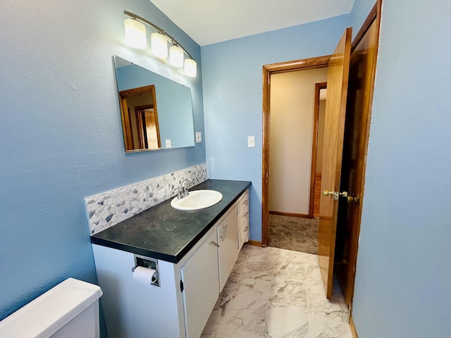 bathroom featuring toilet and vanity