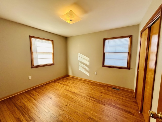 unfurnished bedroom featuring a closet and light hardwood / wood-style flooring